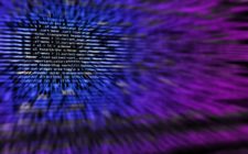 Computer Screen with script in blue and purple blurred
