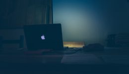 Macbook on Desk in Dark Room