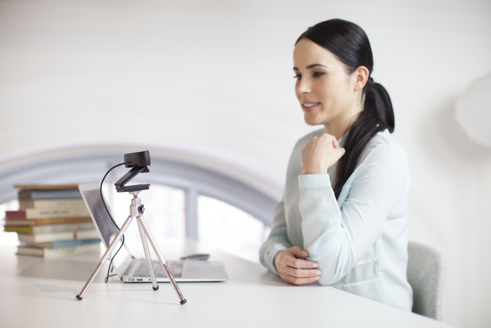 Woman Using Webcam and Laptop