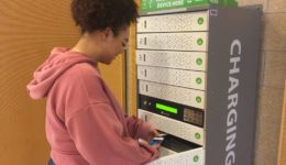 Student using the charging locker to charge mobile phone