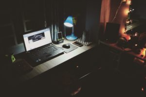 black-laptop-beside-black-computer-mouse-inside-room-669996 (2) Laptop in dark room on a desk with a blue lap shinning