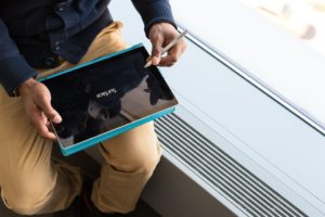 Close-up of man using a surface tablet