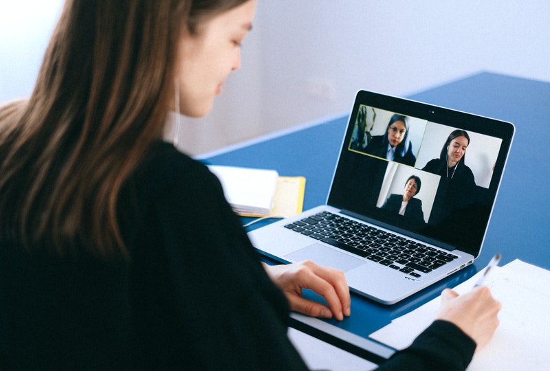 Person on a video conferencing call with three people on the screen