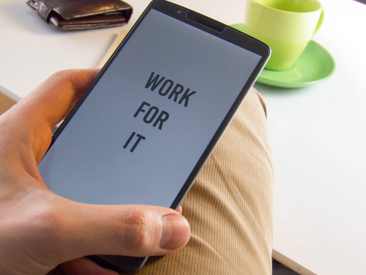 Cell phone with text "WORK FOR IT"