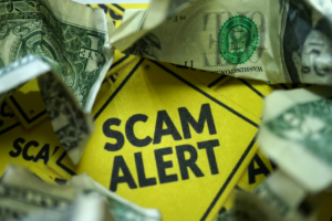 Scam Alert text Surrounded by Crumpled US Bills